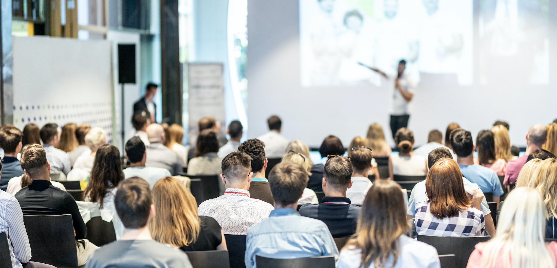 Business speaker giving a talk at business conference event.